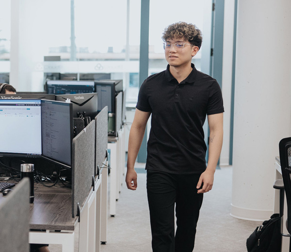 An employee walking through the open office