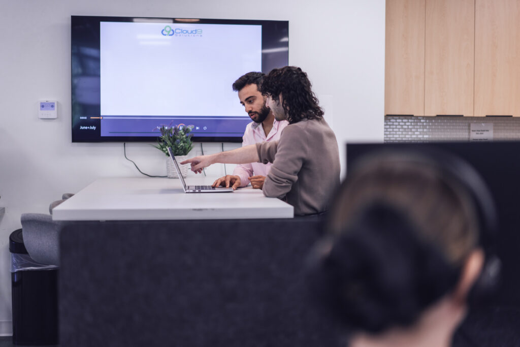 Two coworkers working in the office kitchen