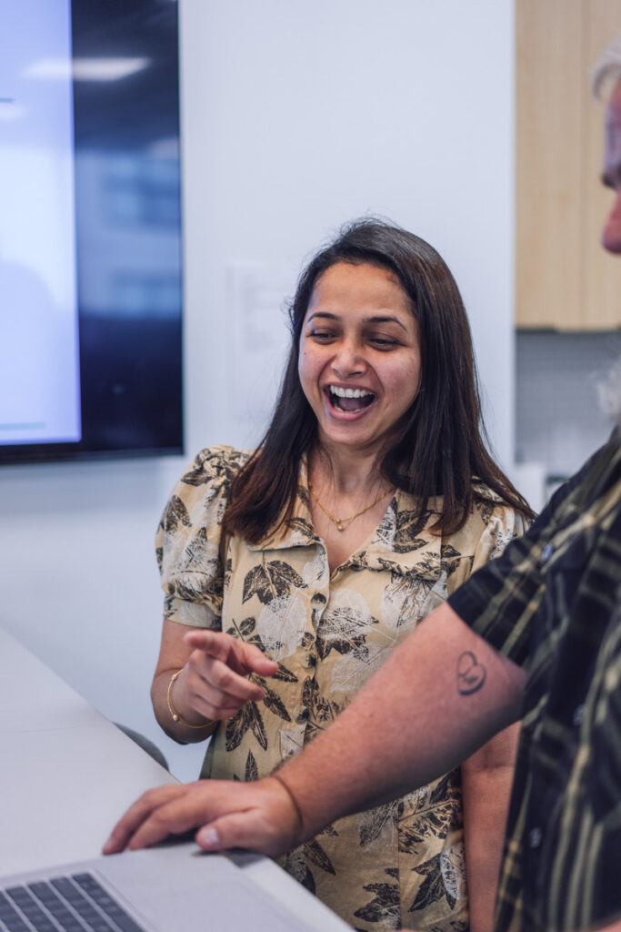 Two employees chatting and laughing