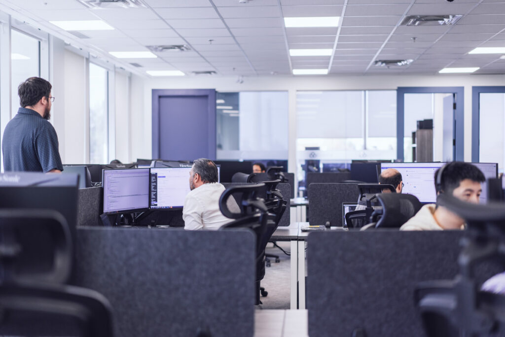 A group of coworkers sitting at their workstations