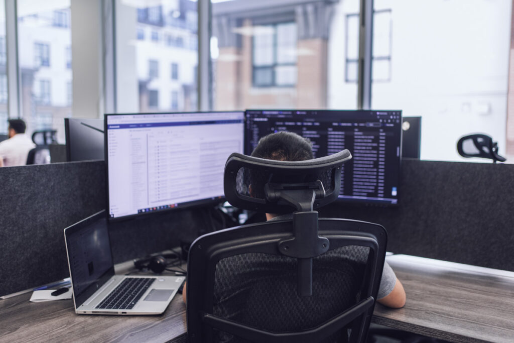 An employee sitting at their workstation