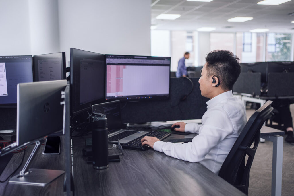 An employee sits at their workstation