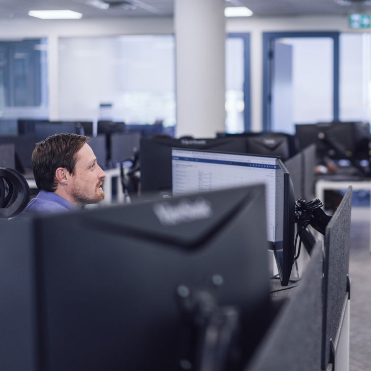 An employee sitting at their workstation